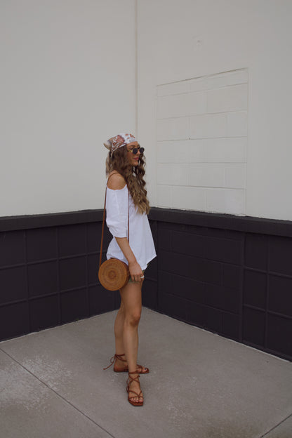 festival outfit for summer. Simple white shirt with statement shorts. Headscarf and purse for accessories